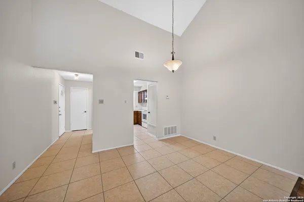 an empty room with white walls and tiles