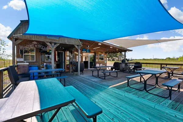 a living room with furniture a table and kitchen view