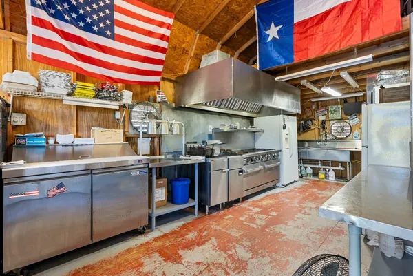 a kitchen with a stove and a refrigerator