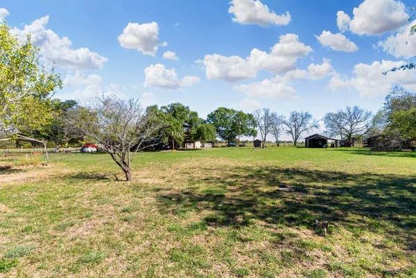 a view of the patio with table and chairs potted plants and floor to ceiling window