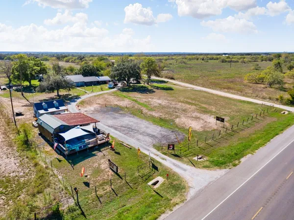 an aerial view of a house with outdoor space and lake view