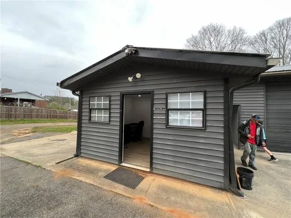 a room with wooden floor and windows