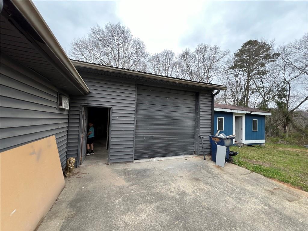 5536 Jackson Trail Road Hoschton, GA 30548 - Photo 4 of 41 a view of a house with a yard and garage