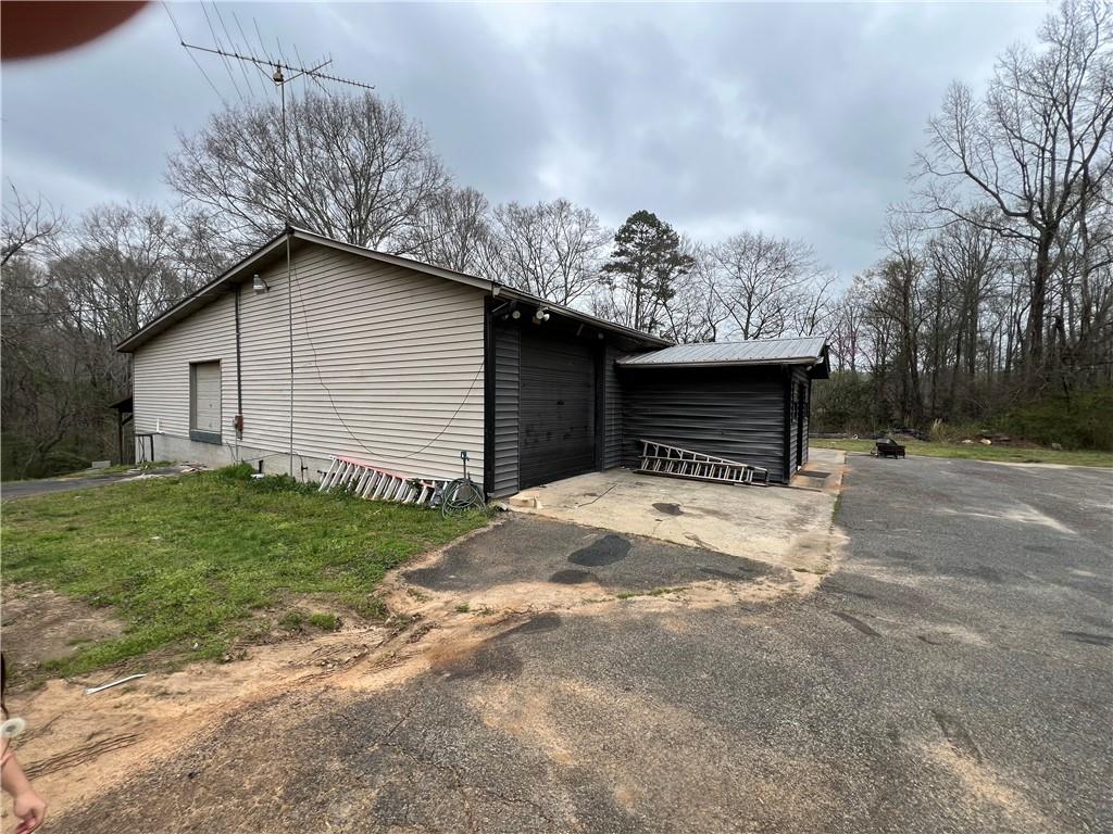 5536 Jackson Trail Road Hoschton, GA 30548 - Photo 10 of 41 a front view of a house with a yard and garage