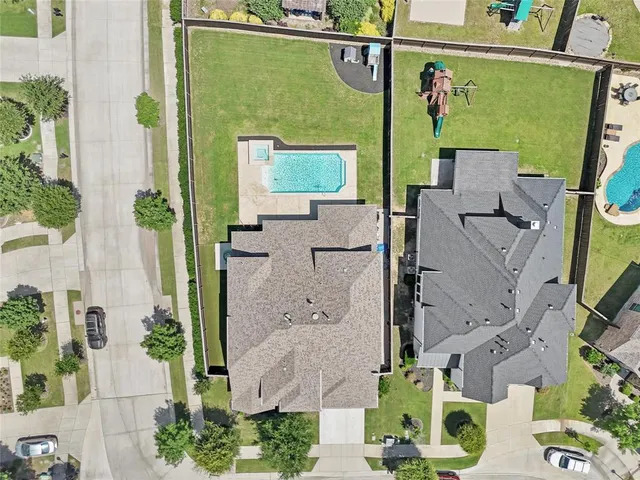 an aerial view of a house with a yard