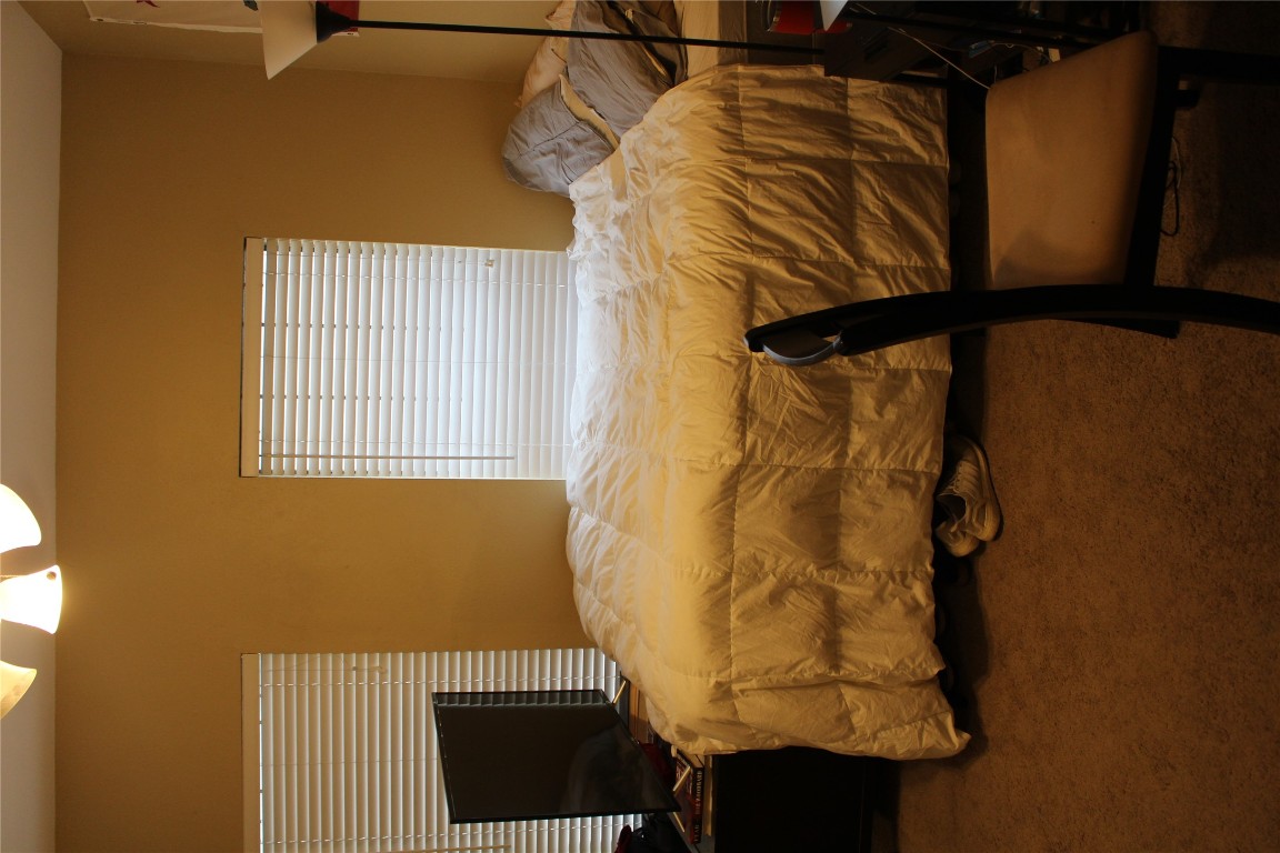 2801 Rio Grande Street, Unit 202 Austin, TX 78705 - Photo 30 of 38 a bedroom with a bed and a fireplace