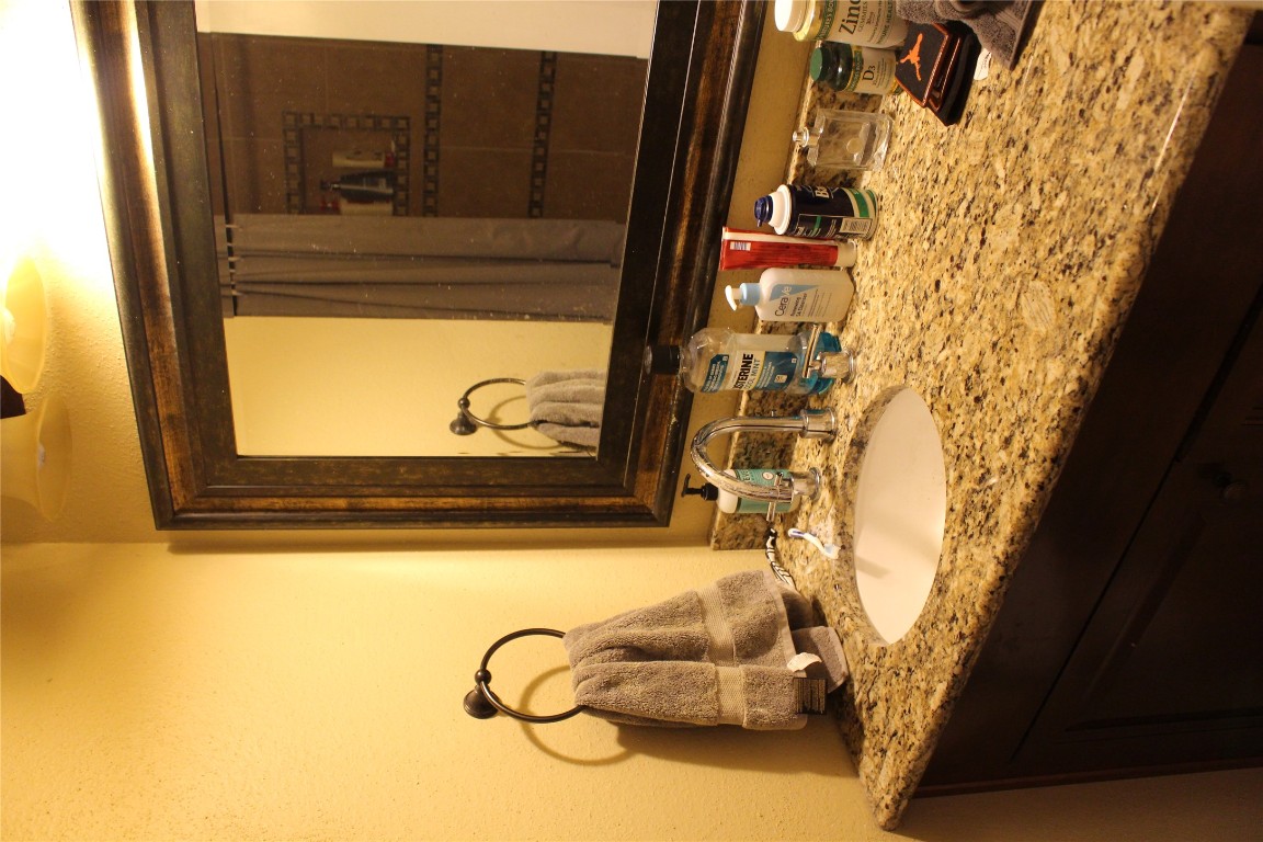 2801 Rio Grande Street, Unit 202 Austin, TX 78705 - Photo 31 of 38 a bathroom with a sink and a mirror