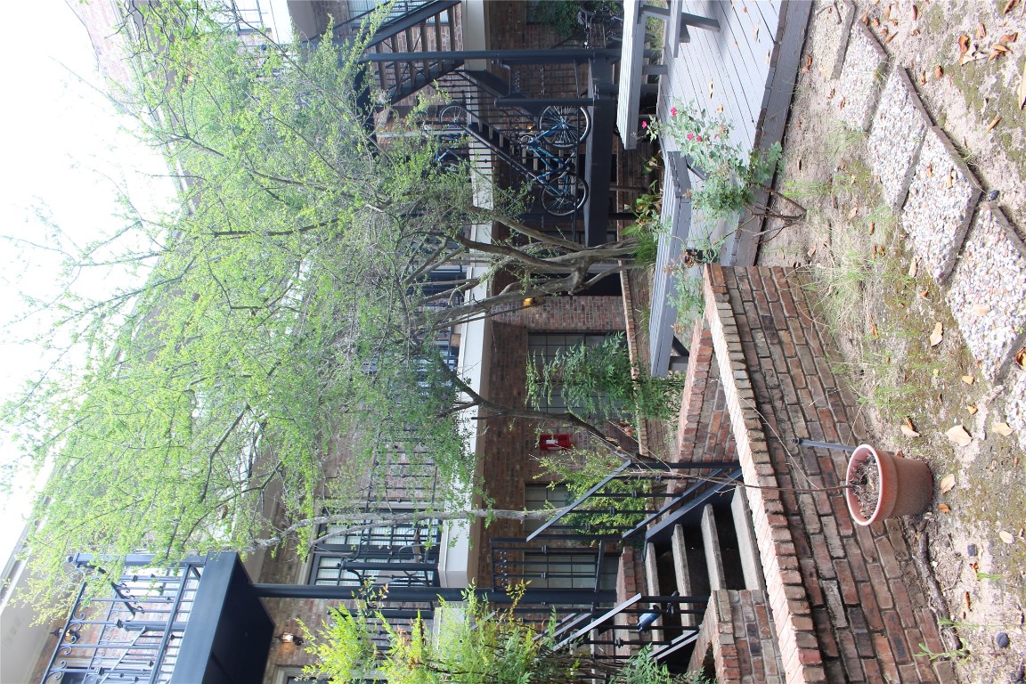 2801 Rio Grande Street, Unit 202 Austin, TX 78705 - Photo 33 of 38 a view of a house with backyard porch and sitting area