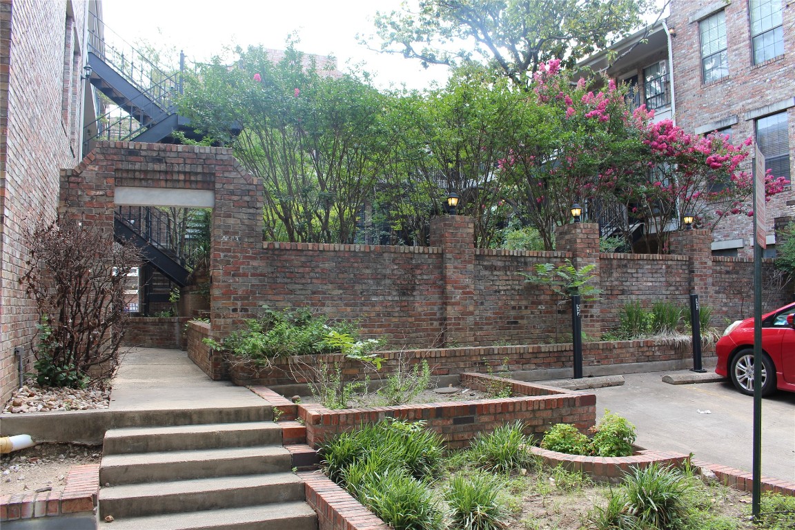 2801 Rio Grande Street, Unit 202 Austin, TX 78705 - Photo 37 of 38 a view of house with a yard and potted plants