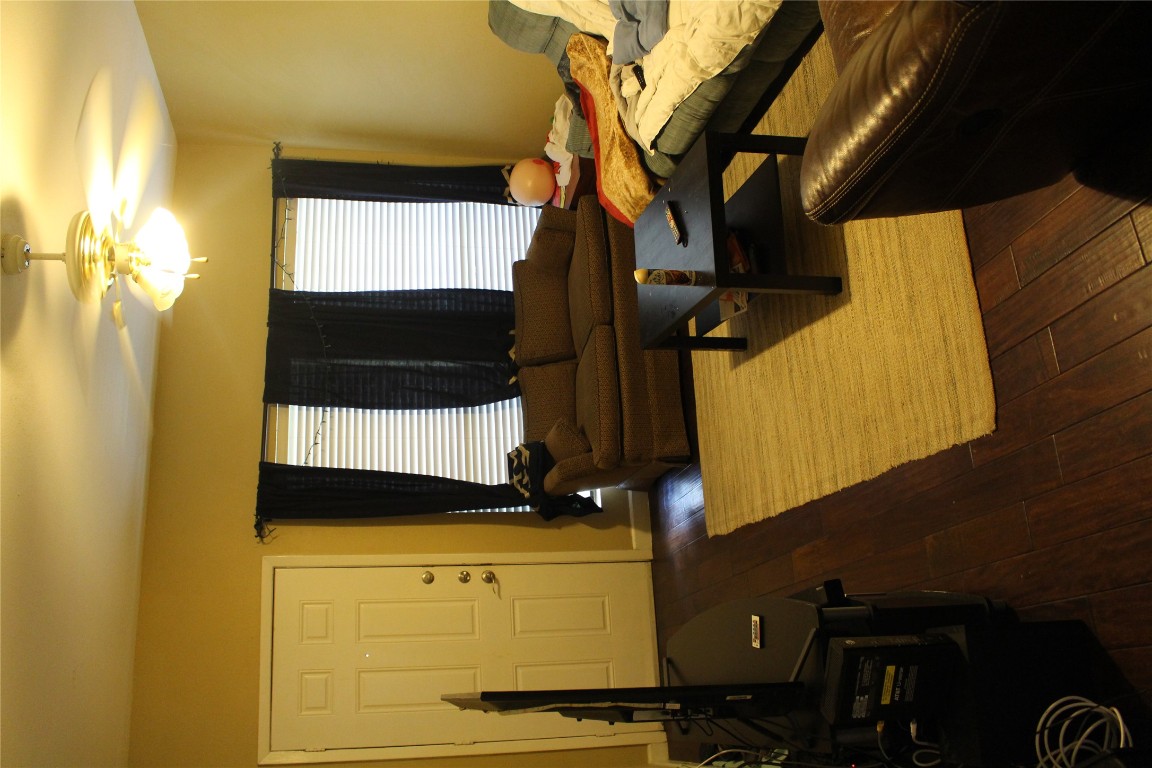 2801 Rio Grande Street, Unit 202 Austin, TX 78705 - Photo 9 of 38 a living room with a table and a flat screen tv