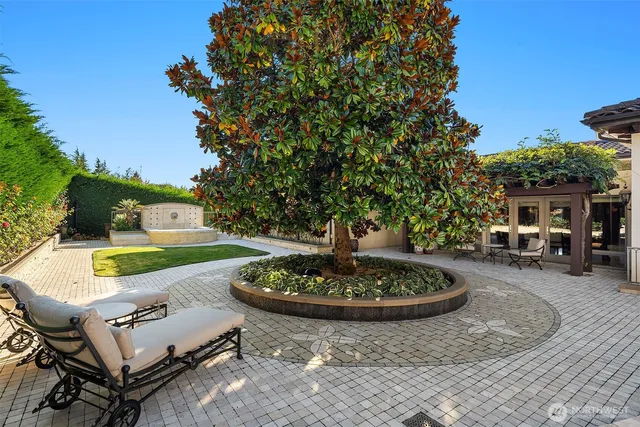 a patio with a table and chairs and a fire pit