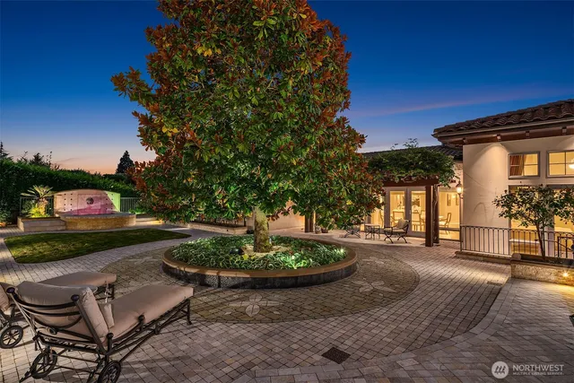 a swimming pool with outdoor seating and plants