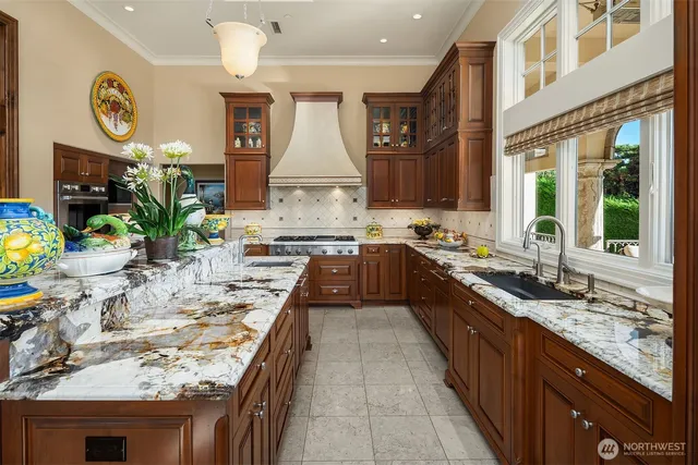 a kitchen with stainless steel appliances granite countertop a stove and a sink