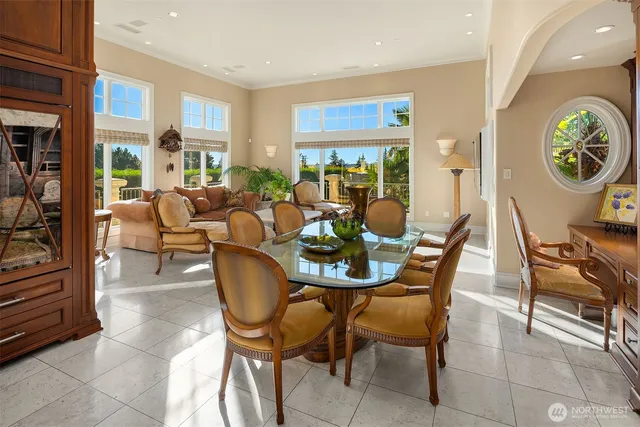 a living room with furniture a table and large windows
