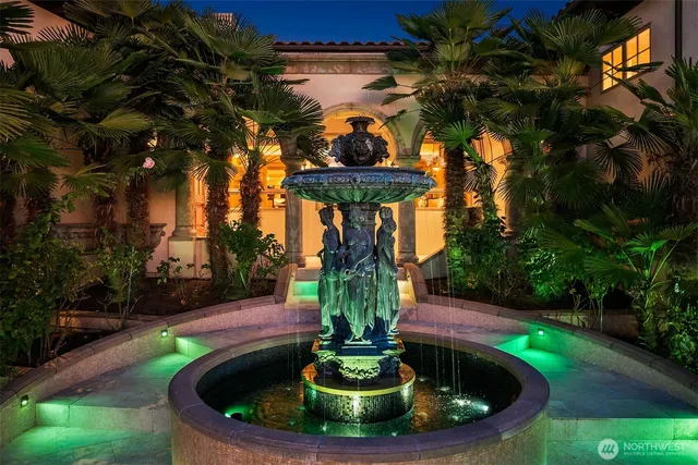 a view of a fountain in the yard of a house