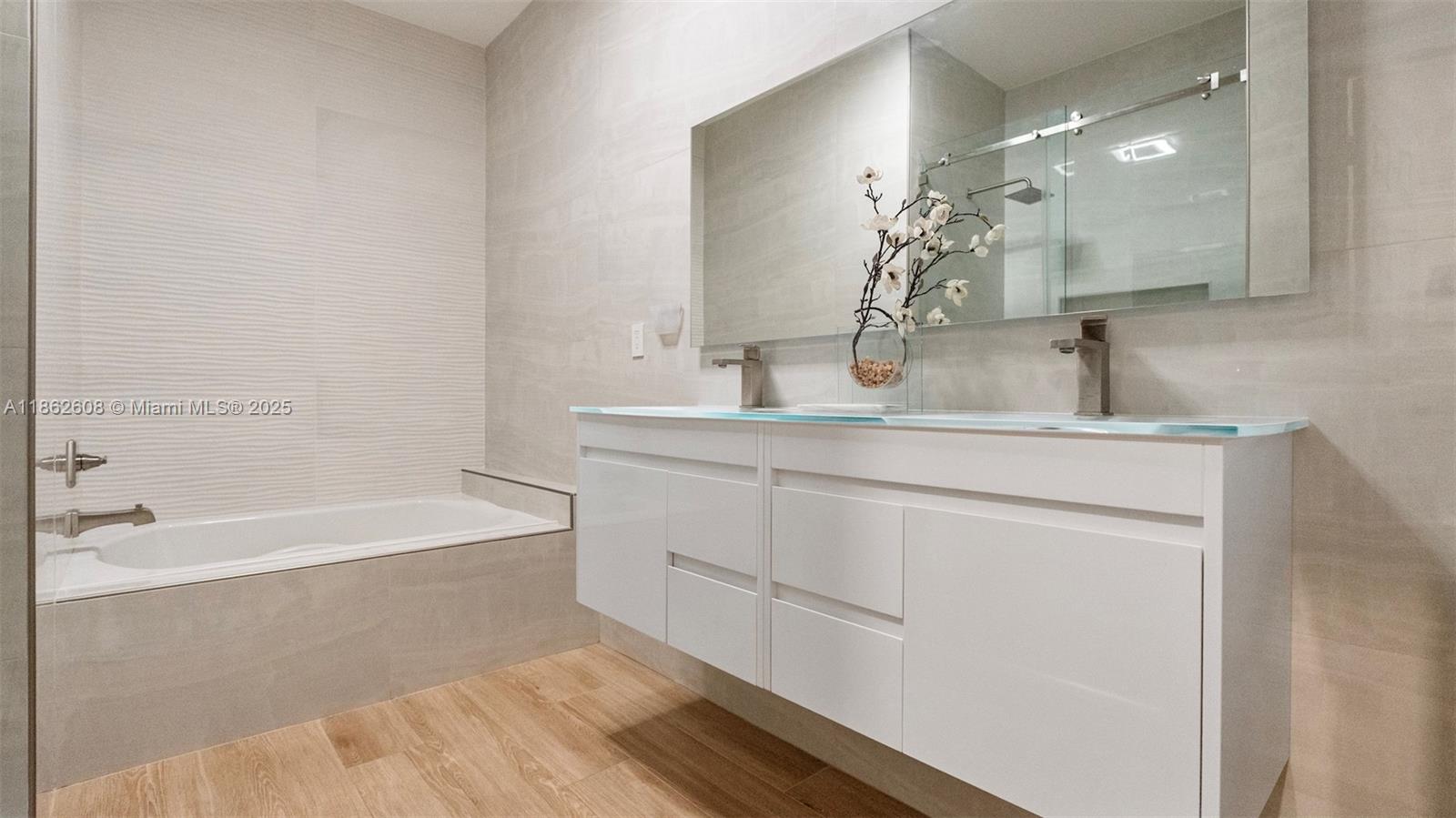 2547 Southwest 119th Terrace Miramar, FL 33025 - Photo 22 of 41 a bathroom with a bathtub sink and mirror