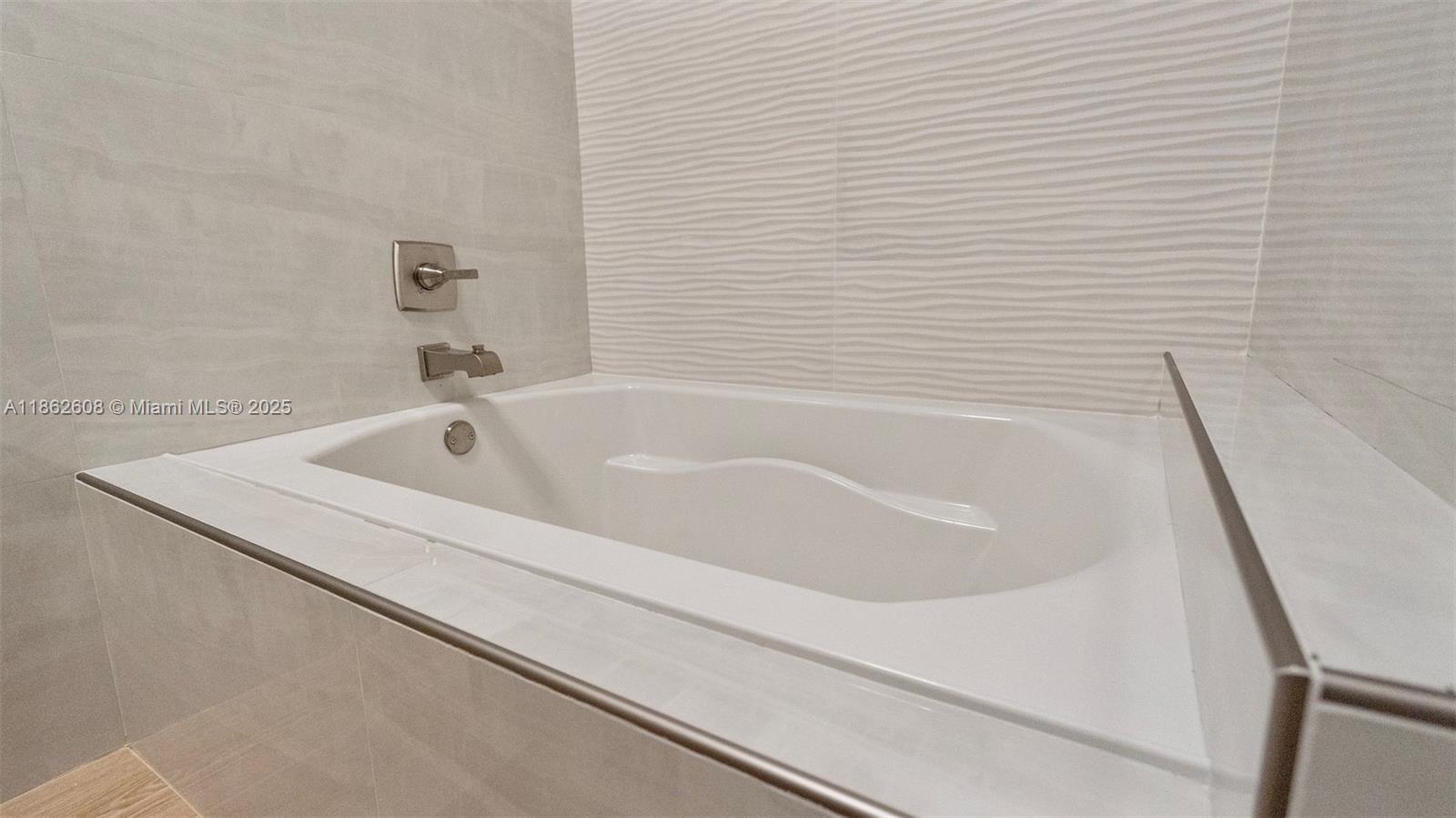 2547 Southwest 119th Terrace Miramar, FL 33025 - Photo 23 of 41 a white bath tub sitting next to a white sink