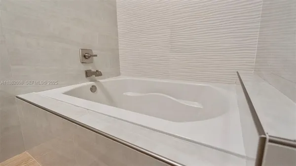 a white bath tub sitting next to a white sink