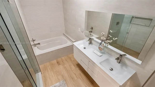 a bathroom with a double vanity sink a mirror and shower