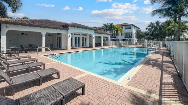 swimming pool view with a seating space