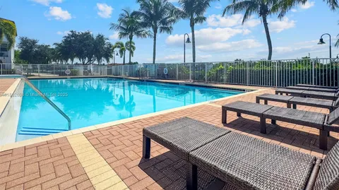 a view of a swimming pool with a patio and a lake view