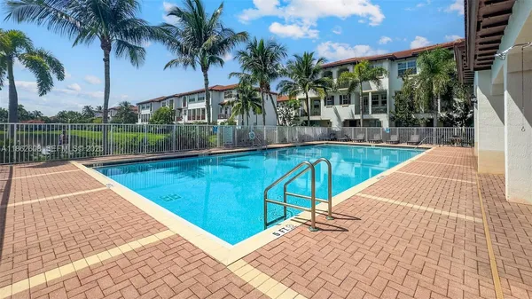 a view of swimming pool with a patio and a lake view