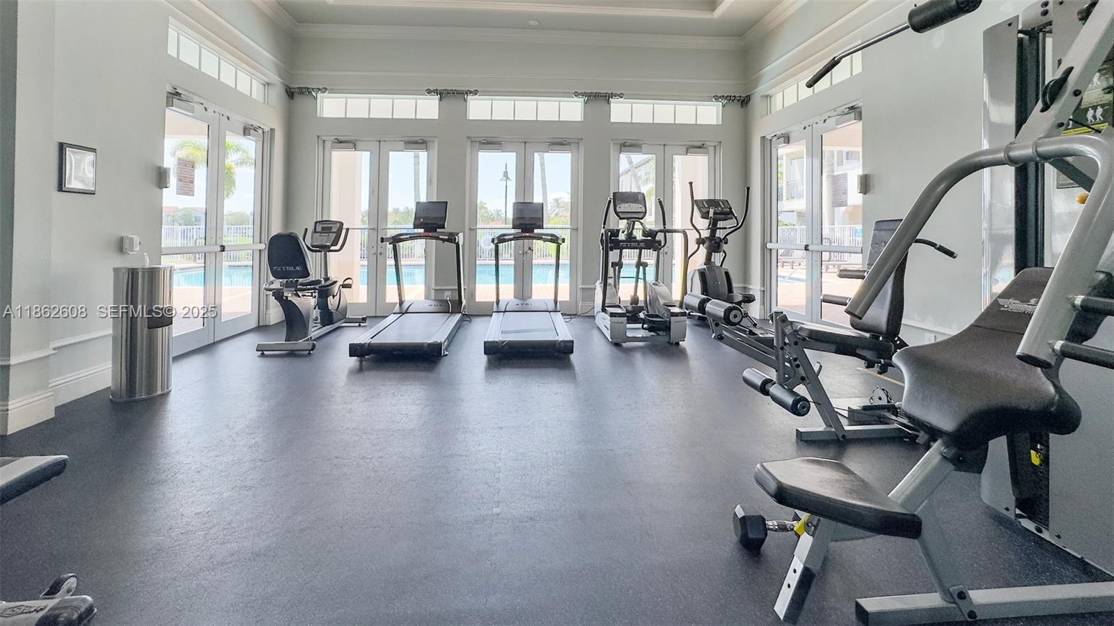 2547 Southwest 119th Terrace Miramar, FL 33025 - Photo 36 of 41 a view of a room with gym equipment and floor to ceiling windows