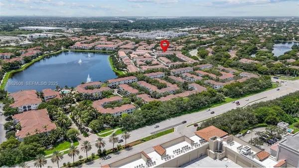 an aerial view of residential houses with outdoor space and swimming pool