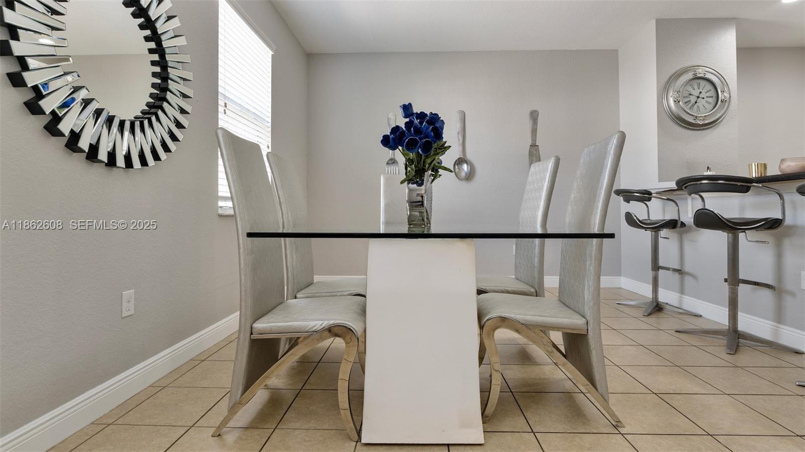 2547 Southwest 119th Terrace Miramar, FL 33025 - Photo 7 of 41 a view of a dining area with furniture and a potted plant