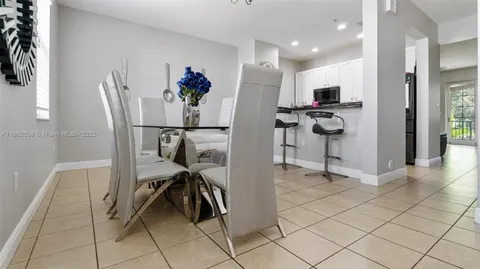 a view of a kitchen with refrigerator and dining table
