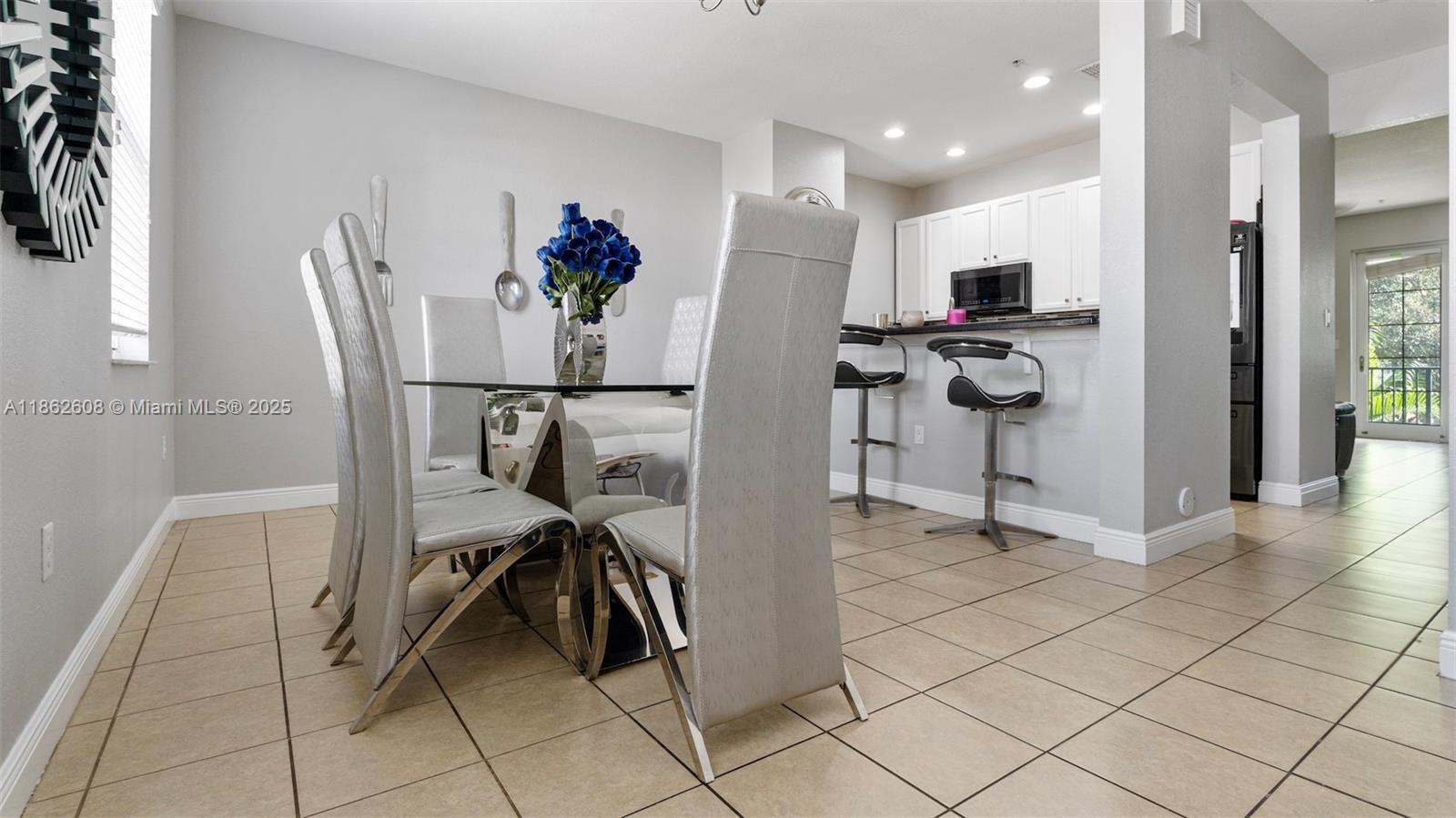 2547 Southwest 119th Terrace Miramar, FL 33025 - Photo 9 of 41 a view of a kitchen with refrigerator and dining table