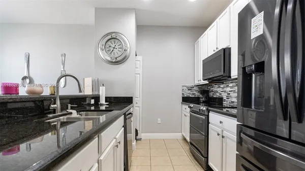 a kitchen with a sink cabinets and stainless steel appliances