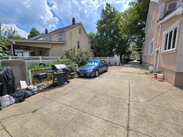 a car parked in front of white house