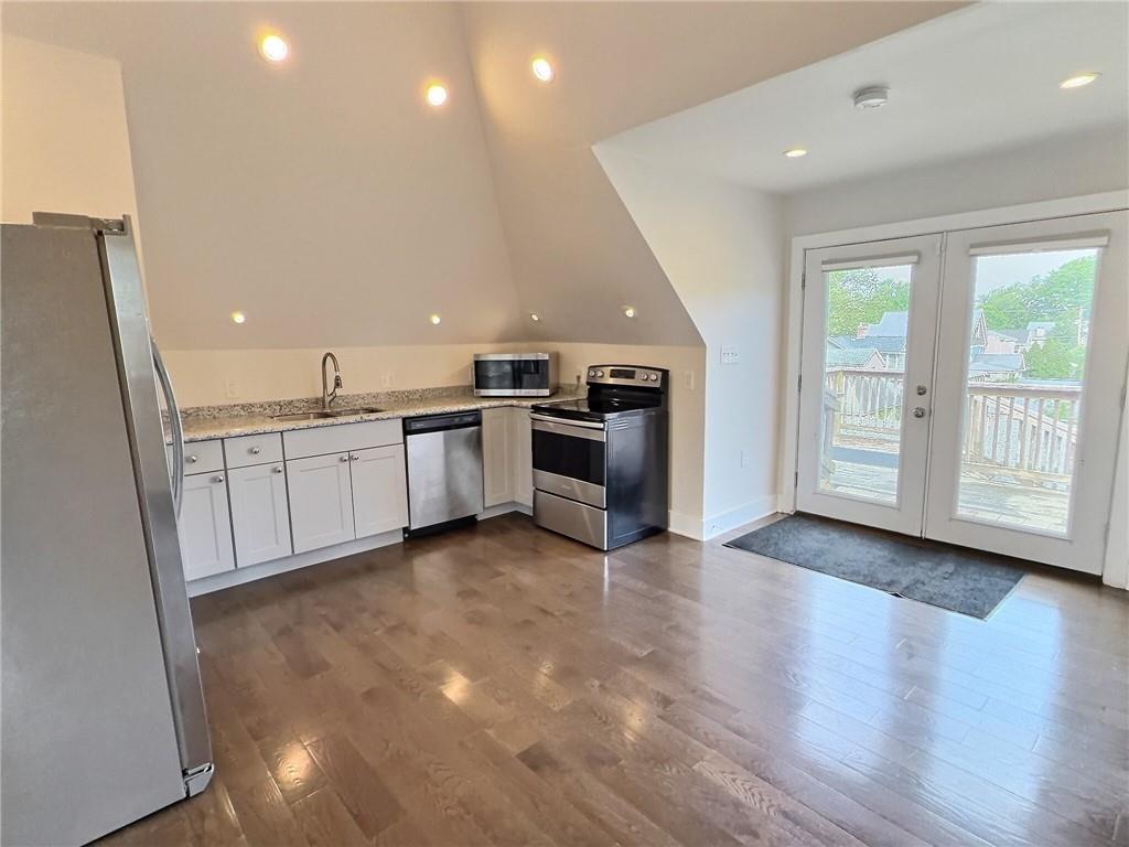 611 Blackburn Road, Unit 3 Sewickley, PA 15143 - Photo 5 of 16 a view of a kitchen with a sink stove cabinets and empty room