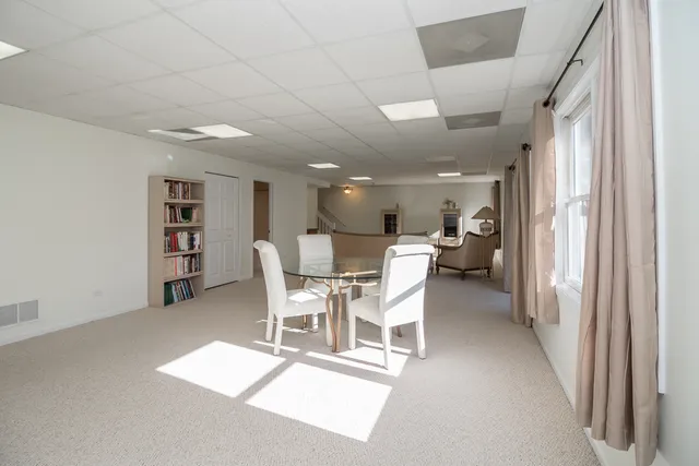 a dining room with furniture and a wooden floor