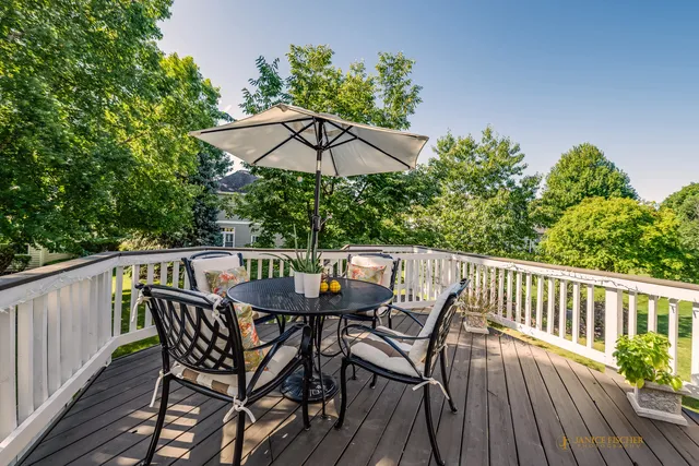 a view of balcony with furniture and umbrella