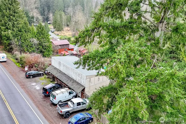 a view of a livingroom with furniture a flat screen tv and floor to ceiling window