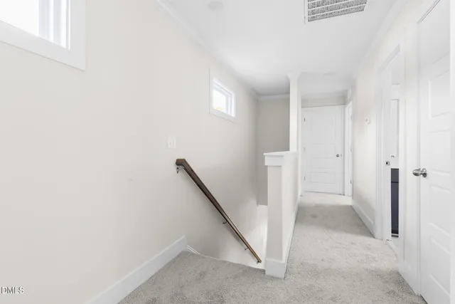 an empty room with a window and a ceiling fan