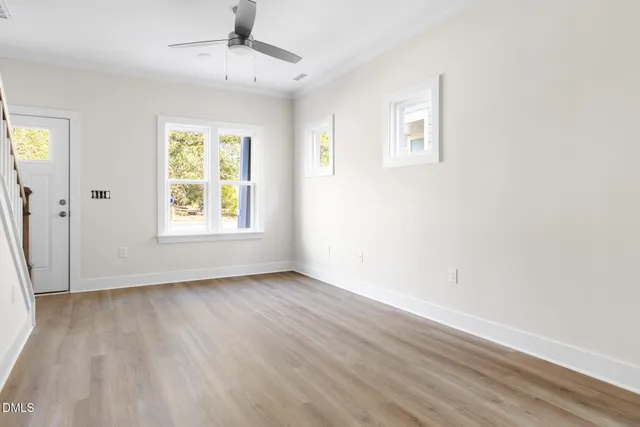 wooden floor in an empty room with a window
