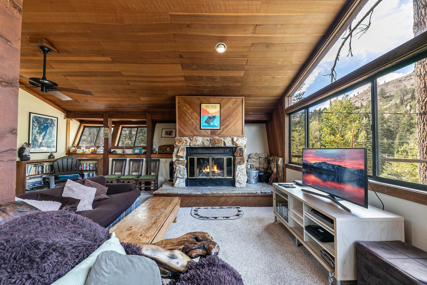 1786 Trapper Place Alpine Meadows, CA 96146 - Photo 4 of 16 a living room with furniture large window and a fireplace