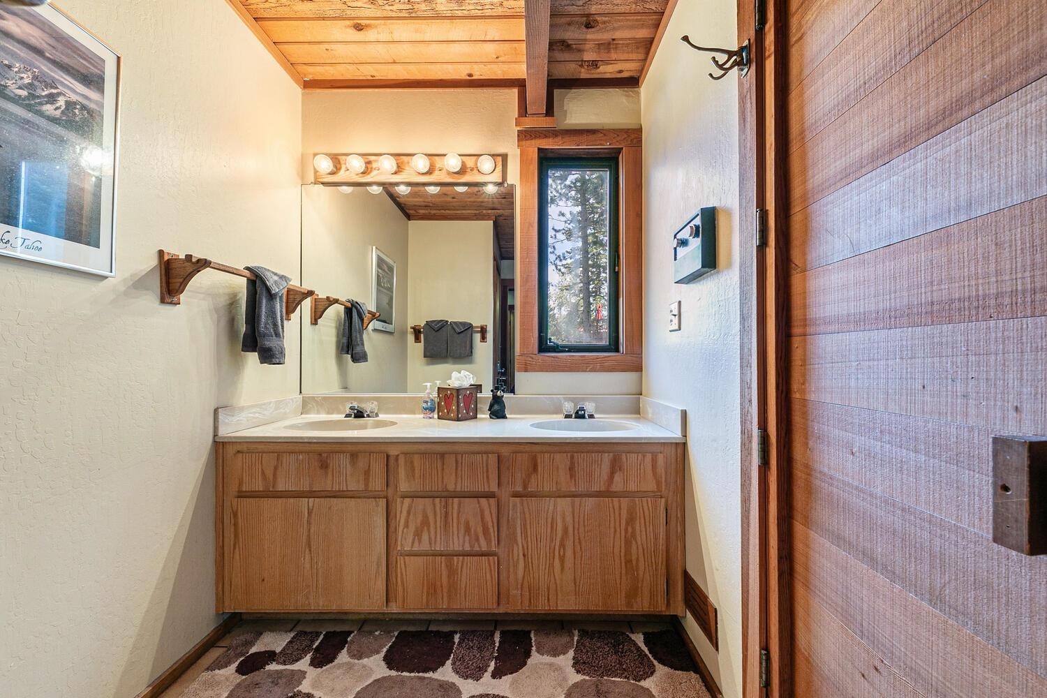 1786 Trapper Place Alpine Meadows, CA 96146 - Photo 8 of 16 a bathroom with a sink a mirror and a shower