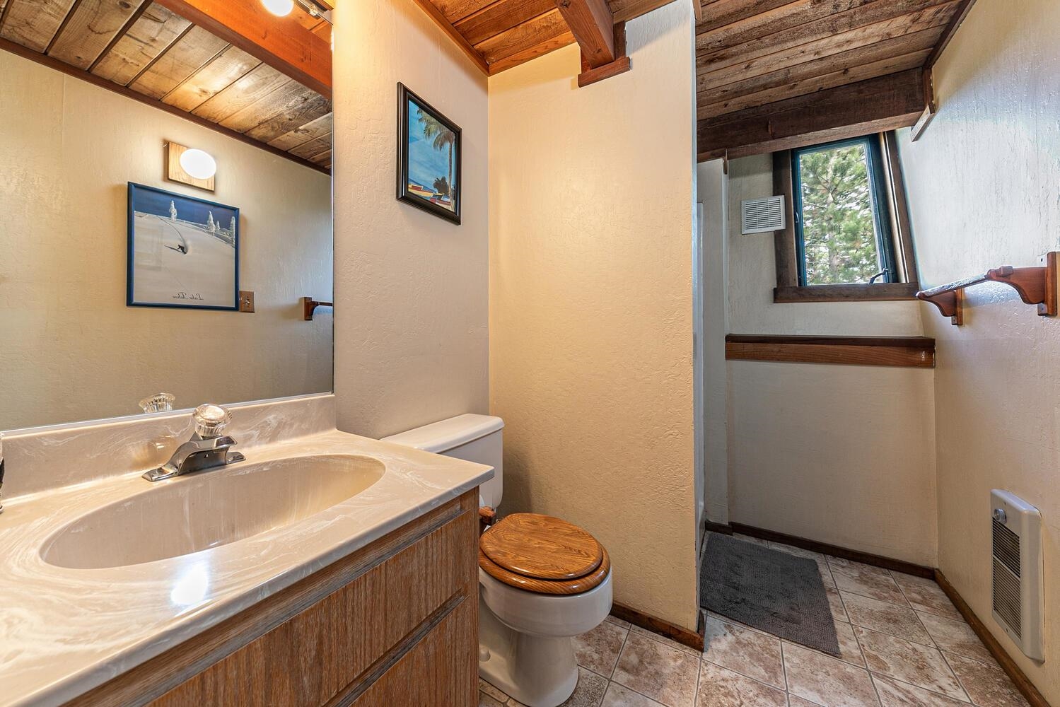 1786 Trapper Place Alpine Meadows, CA 96146 - Photo 9 of 16 a bathroom with a sink toilet and window