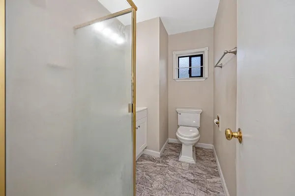 a bathroom with a toilet and a shower