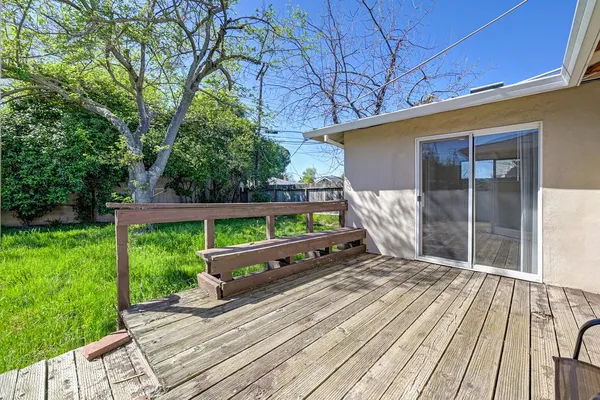 a wooden bench sitting in front of a house