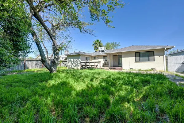 a front view of a house with yard and green space