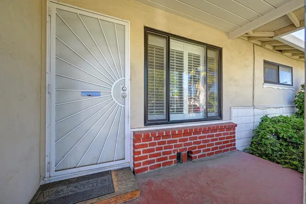 a view of front door with a small yard