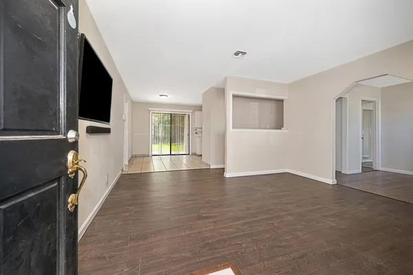 a view of a livingroom with wooden floor and a window