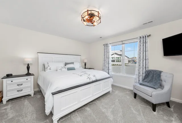 a bedroom with a bed and a couch