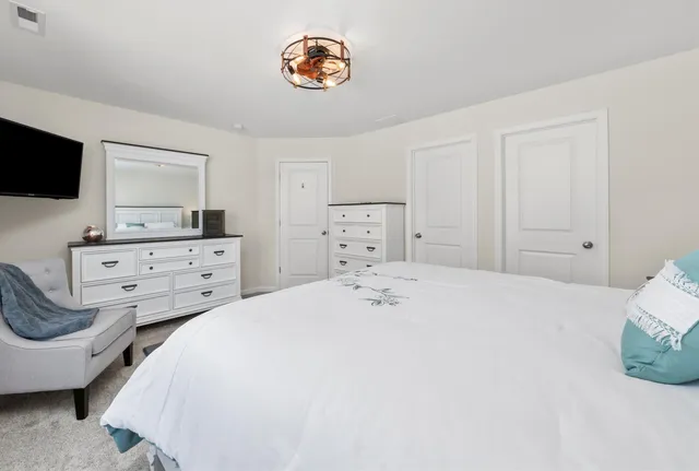 a bedroom with a bed and a television