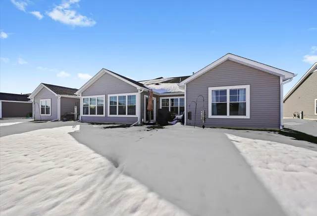 a front view of a house with yard and parking